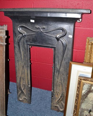 Lot 568 - An Art Nouveau style cast iron fire surround - lacking insert