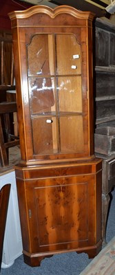 Lot 587 - Yew wood corner cabinet with two keys