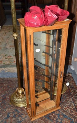 Lot 589 - Pair of brass standard lamps with shades and an oak cased wall mounted cabinet