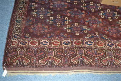 Lot 626 - Yomut carpet, Emirate of Bukhara, the aubergine field with columns of Kepse guls enclosed by...