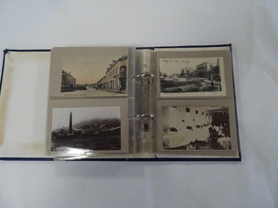 Lot 366 - A blue album containing approx. 100 postcards...