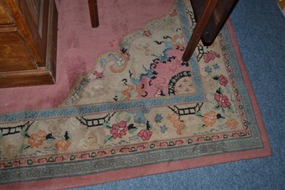 Lot 643 - European machine made carpet, the plain coral field centred by a panel enclosed by spandrels...