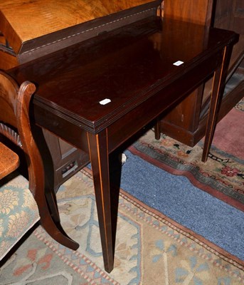 Lot 649 - A dark mahogany inlaid fold-over tea table