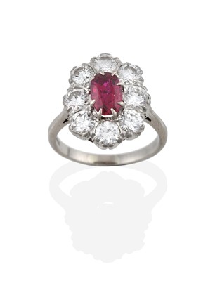 Lot 2260 - A Ruby and Diamond Cluster Ring, the oval cut...