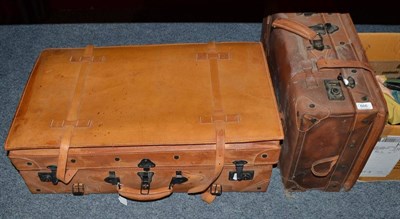 Lot 666 - Graduated set of three Giovanni tan leather suitcases with leather straps and metal locks,...