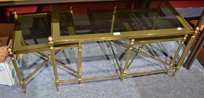 Lot 667 - A brass nest of three occasional tables