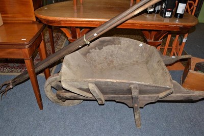 Lot 698 - A wooden wheelbarrow and four hay forks