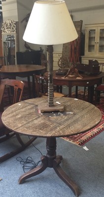 Lot 1164 - An 18th century oak tilt top tripod table...