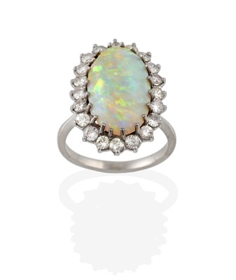 Lot 2323 - An Opal and Diamond Cluster Ring, the oval...