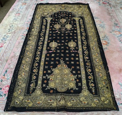 Lot 1257 - A large black wool eastern wall hanging...