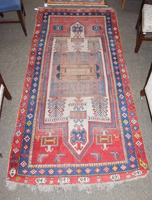 Lot 1237 - Kazak rug, the blood red field with ivory...