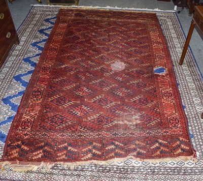 Lot 354 - Yomut carpet, the feld of dyrnak güls ensloed...