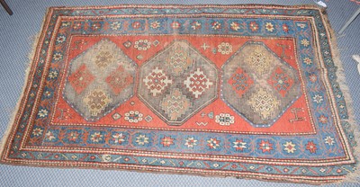 Lot 369 - Kazak rug, the madder field with three...