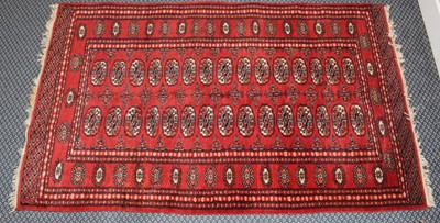 Lot 365 - A Pakistan 'Bukhara' rug, the brick red field...