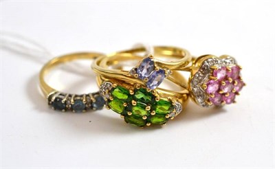 Lot 18 - Four 9ct gold rings set with diamond and gemstones including tanzanite etc