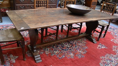 Lot 1071 - An Oak Dining Table, the plank top on trestle...