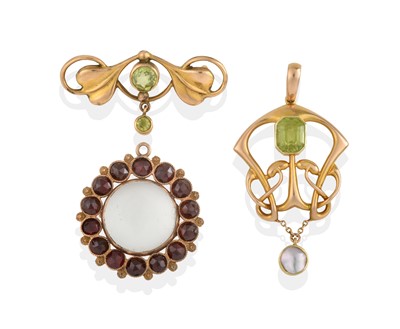 Lot 2317 - A Peridot and Mother-of-Pearl Pendant, A Peridot Brooch and A Garnet Pendant
