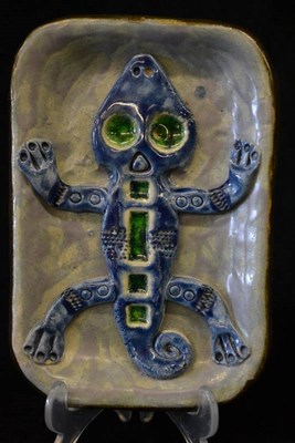 Lot 883 - A Troika Plaque, modelled with a geco with green eyes and blue body, on a purple wash ground,...