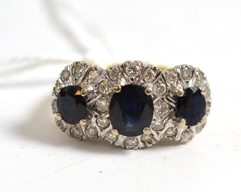 Lot 52 - An 18ct gold sapphire and diamond triple cluster ring