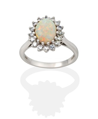 Lot 2345 - An 18 Carat White Gold Opal and Diamond Cluster Ring