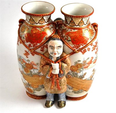 Lot 75 - A Japanese kutani porcelain vase modelled as two vases with a figure of a man standing either side