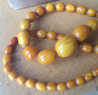 Lot 110 - An amber type bead necklace, length 83cm...