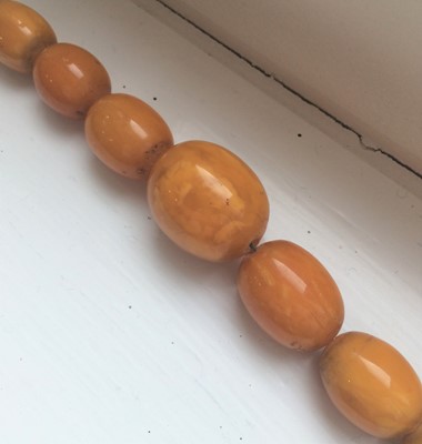 Lot 110 - An amber type bead necklace, length 83cm...