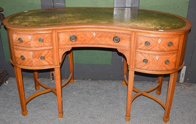 Lot 451 - An Edwardian satinwood reniform writing table...