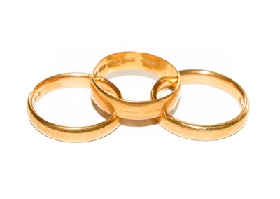 Lot 138 - Three 22 carat gold band rings, finger sizes P,...