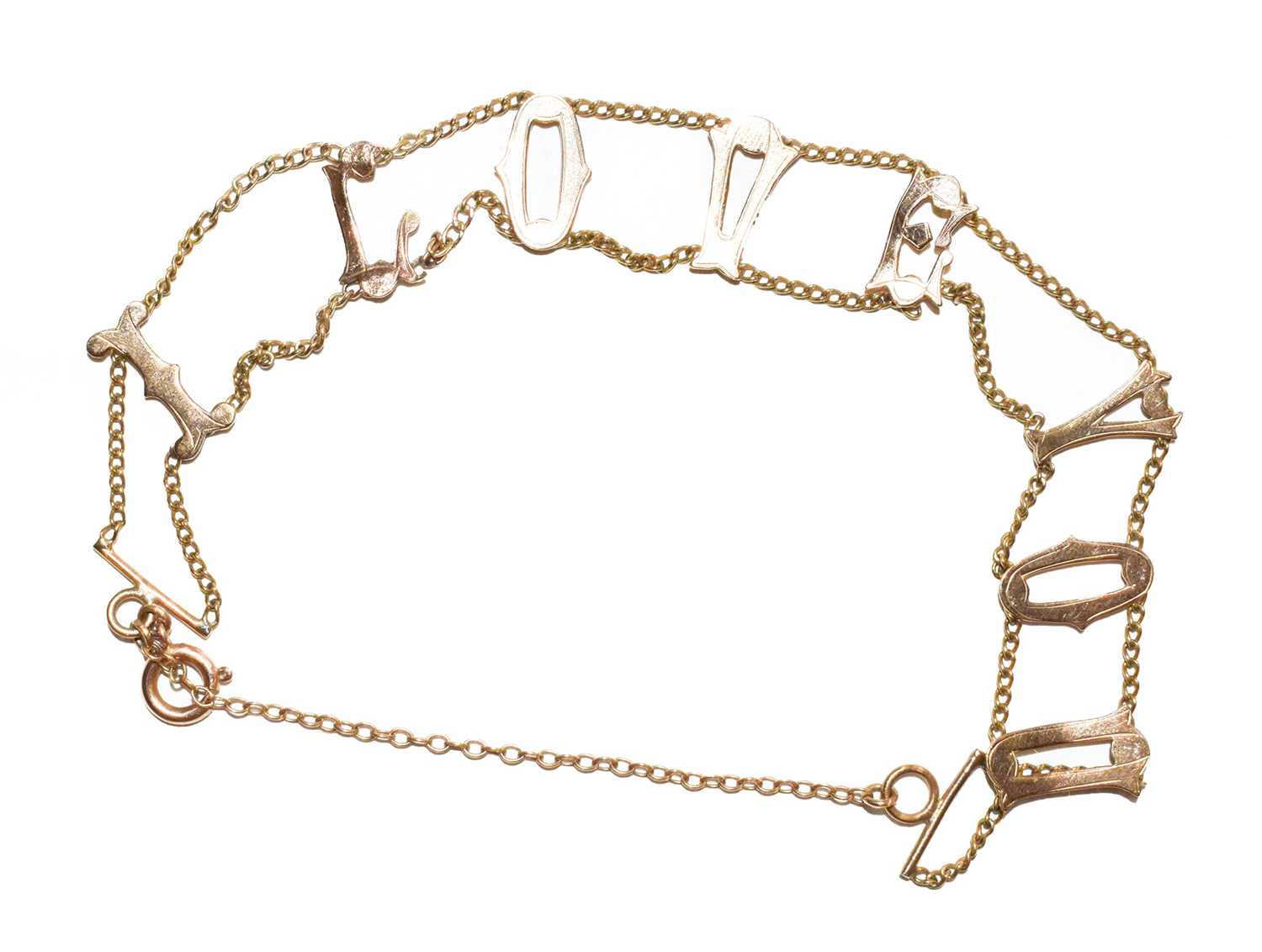 Lot 130 - A fancy link bracelet, depicting the letters...