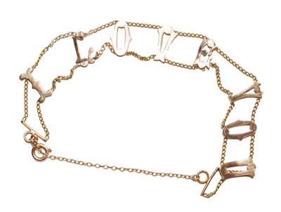 Lot 130 - A fancy link bracelet, depicting the letters...