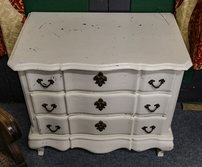 Lot 1134 - A cream painted three-height chest of drawers,...
