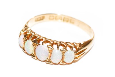 Lot 129 - An 18 carat gold opal five stone ring, finger...