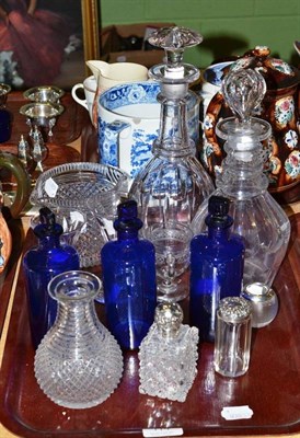 Lot 114 - A cut glass rinser, a small bottle, two decanters, a striker, three glasses, three blue bottles and
