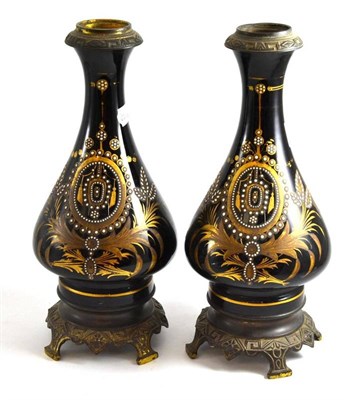 Lot 116 - A pair of metal mounted lamps in black with enamel decoration