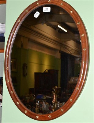 Lot 136 - A decorative oval wall mirror