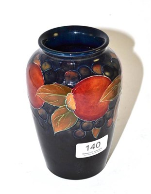 Lot 140 - A William Moorcroft Pomegranate pattern vase, on a blue ground, impressed facsimile signature...