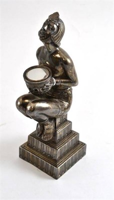 Lot 157 - An Art Deco style plated figure, modelled as a seated Egyptian maiden on a stepped base,...