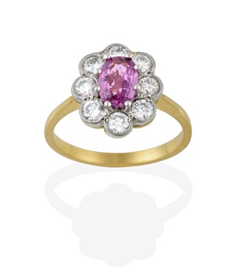 Lot 2334 - A Pink Sapphire and Diamond Cluster Ring, the...