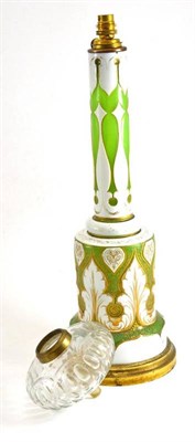 Lot 242 - 19th century Bohemian green glass oil lamp base with white overlay, gilt highlights and gilt mounts