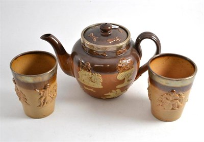 Lot 269 - Doulton stoneware teapot and two beakers