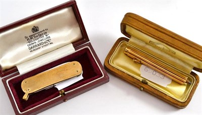 Lot 314 - A pen knife with 9ct gold scales and suspension loop, also a French 18ct gold 'propelling'...