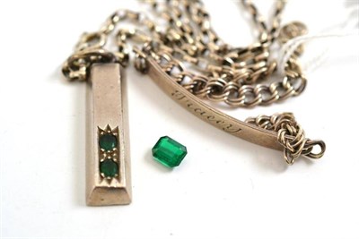 Lot 324 - A loose emerald, an ingot inset with emeralds and an identity bracelet (a.f.)