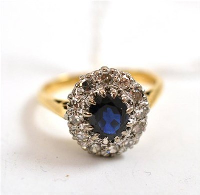 Lot 332 - A sapphire and diamond cluster ring