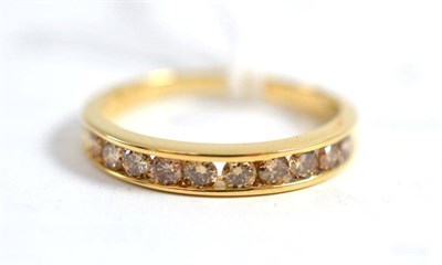 Lot 334 - A 9ct gold diamond half hoop ring, the champagne coloured round brilliant cut diamonds channel set