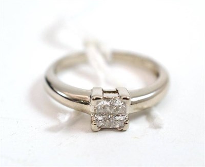 Lot 358 - A platinum diamond cluster ring, four princess cut diamonds tension set, total estimated...