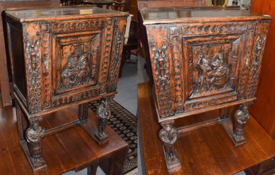 Lot 463 - A pair of ornate Continental oak side cabinets...