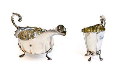 Lot 216 - An Edward VII silver cream jug, by Walker and...