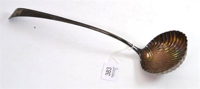 Lot 383 - A Georgian shell pattern soup ladle, with griffin crest