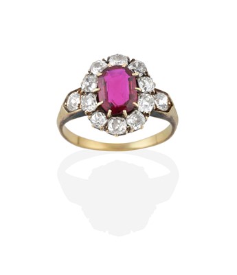 Lot 2280 - A Ruby and Diamond Cluster Ring, the oval cut...